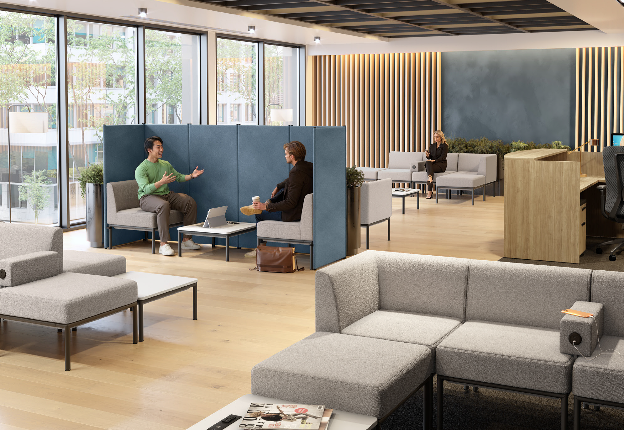 Office lounge area with sofas, lounge chairs, and privacy screens